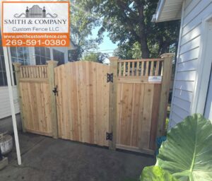 A custom wooden gate with a decorative lattice top section, installed by Smith & Company Custom Fence LLC in Niles, MI.