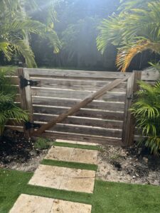 A custom-built wooden gate with horizontal slats, installed by ARE FENCE LLC in Miami, FL.