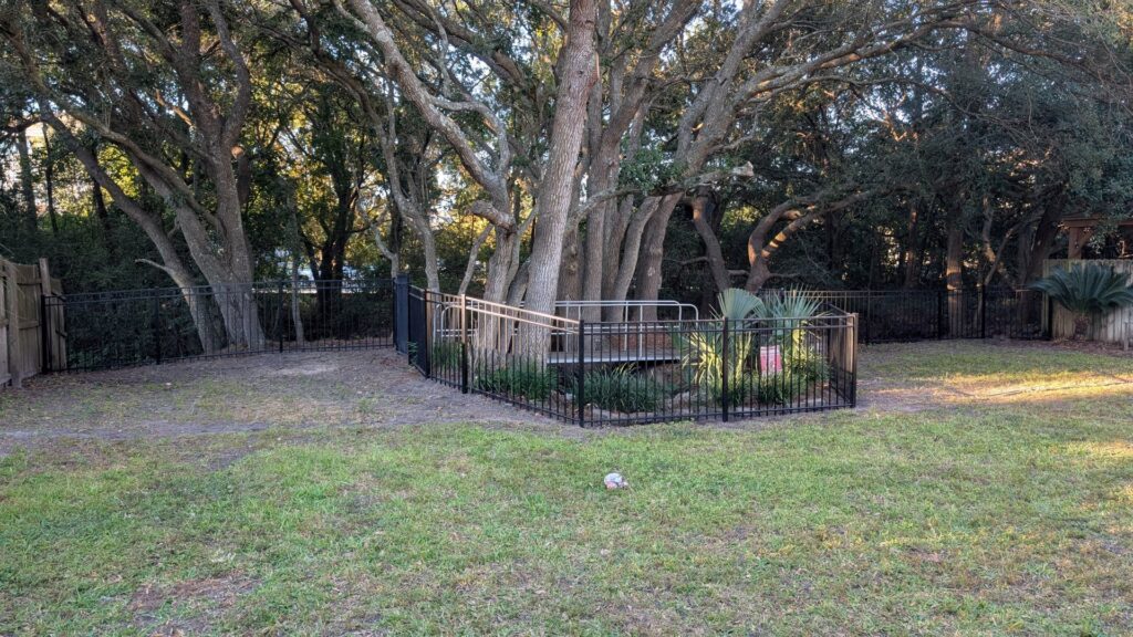 A custom wooden privacy fence and gate installed next to a residential property by Gifford Contracting & Repair in Goose Creek, SC.