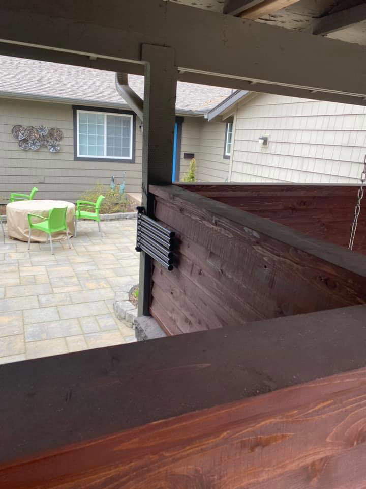 A custom dark stained wooden privacy screen and railing installed by Ram fence in Lewiston, ID