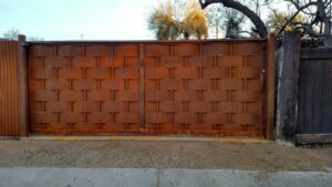 A custom woven metal gate and corrugated fence section installed by Fence Company Tucson in Tucson, AZ.