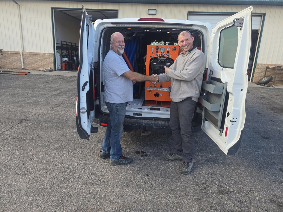 A customer shaking hands after receiving a new truck mount carpet cleaning system from El Diablo Truck Mounts in Rapid City, SD.