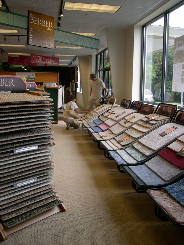 Two individuals browsing various carpet samples in the showroom at Craft Rug Mills in Easton, PA.