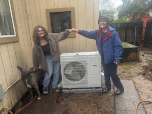 Happy customers next to their new mini-split HVAC installation by Airmech Heating and Air Conditioning in Elk Grove, CA.