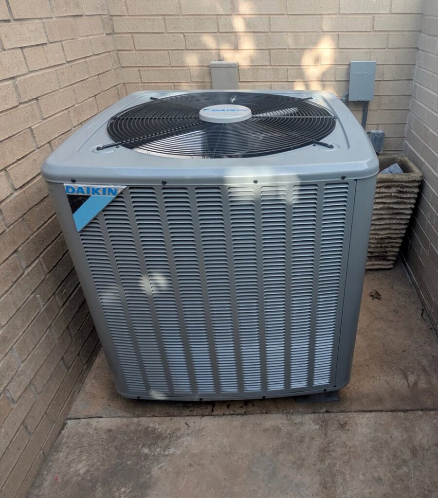 An outdoor Daikin air conditioning condenser unit installed by Totality Heating And Cooling in Edmond, OK.
