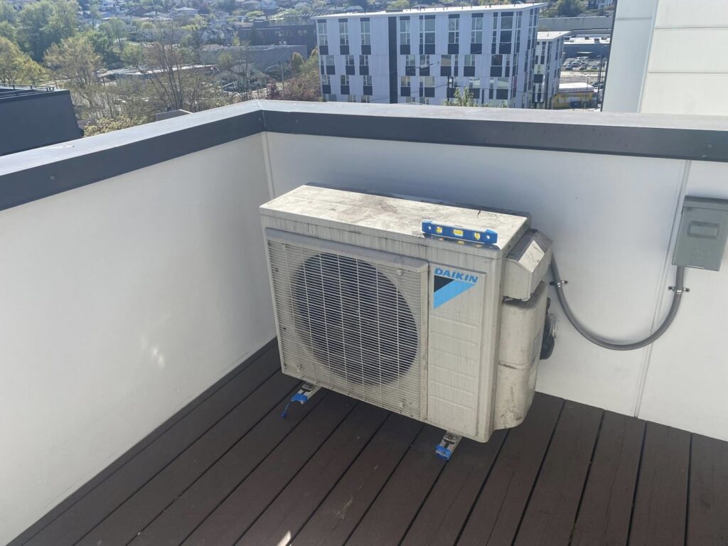 A Daikin air conditioning unit installed on a rooftop deck by JN Heating & Cooling in Eure, NC