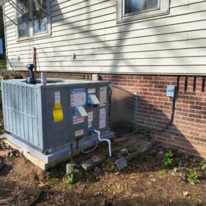 A Daikin outdoor HVAC unit installed next to a residential building, serviced by T & T HVAC in Amherst, OH.