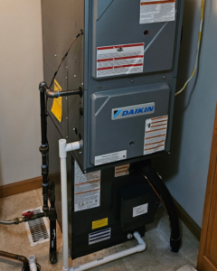 An indoor Daikin HVAC furnace and air handler unit installed by Dixon's Heating & Air Conditioning, Inc. in Athens, IL