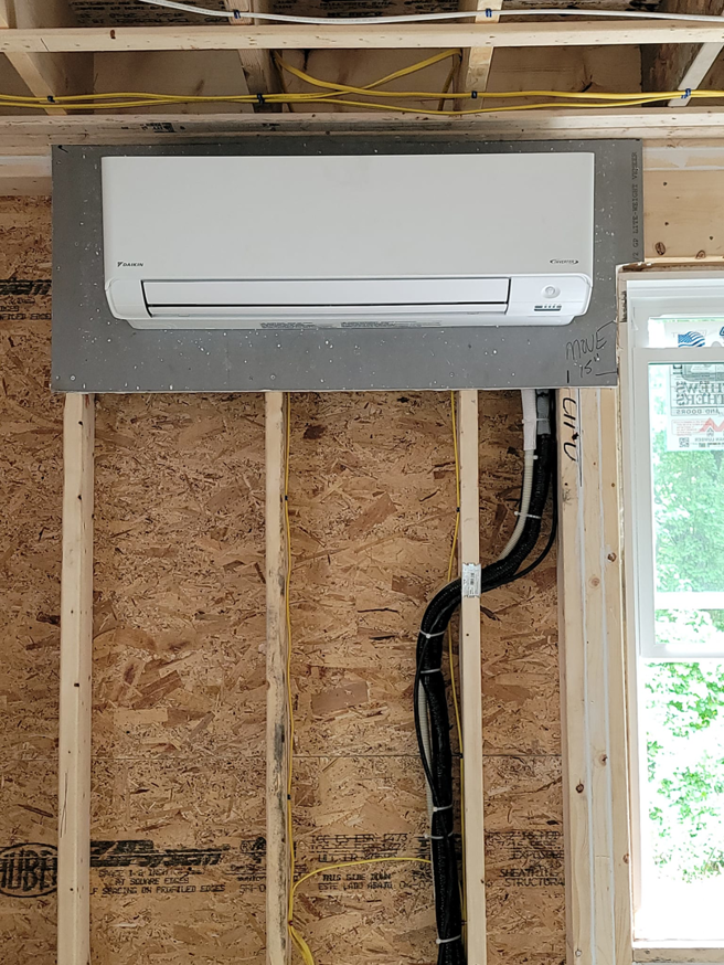 A Daikin mini-split indoor unit being installed on a wall during construction by Mini Split Solutions in Austin, TX