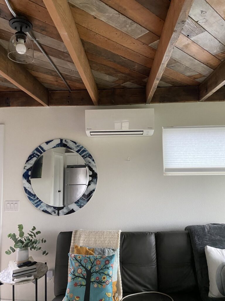 A Daikin mini-split indoor unit installed on a wall in a living room by Heatwave Heating & Air LLC in Federal Way, WA.