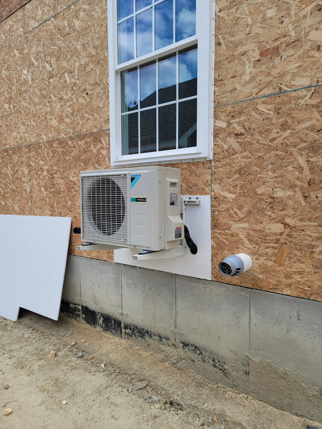 A Daikin mini-split outdoor unit installed on a house under construction by Mini Split Solutions in Austin, TX