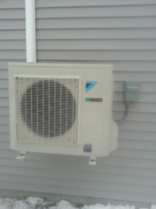 A newly installed Daikin mini-split outdoor unit on the side of a home by Maine Thermal Energy Services in Ellsworth, ME