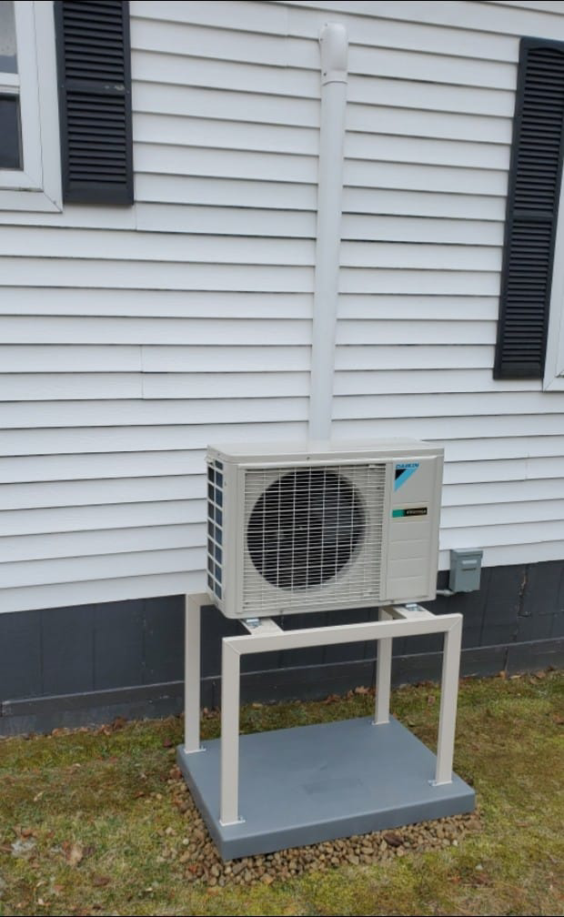 A Daikin mini-split outdoor unit installed on a custom raised stand by Maine Thermal Energy Services in Ellsworth, ME