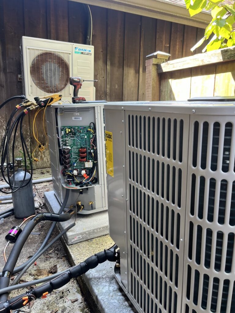 A Daikin outdoor AC unit undergoing service or repair with internal components exposed by McGuffee's Air Conditioning and Heating in Gulfport, MS