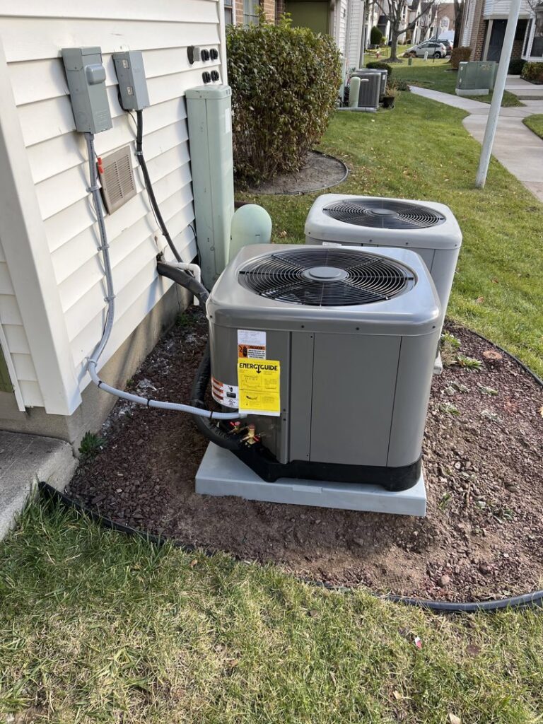 An outdoor Daikin mini-split HVAC unit installed on a wooden stand by Riccardi Heating and Air in Toms River, NJ.