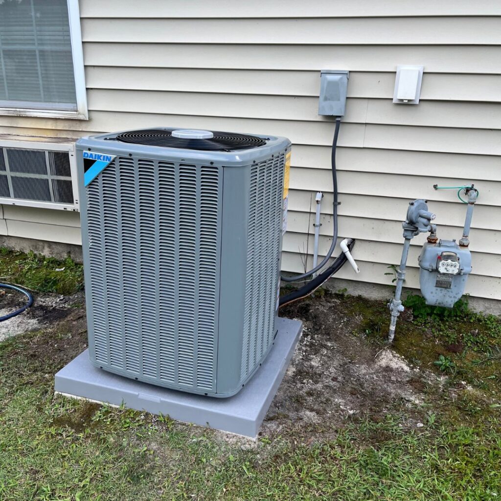 A residential Daikin outdoor HVAC unit on a concrete pad, installed or serviced by T & T HVAC in Amherst, OH.
