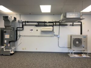 A Daikin VRV HVAC system installation with indoor and outdoor units, likely in a showroom, by Aire Serv of Rochester, NY