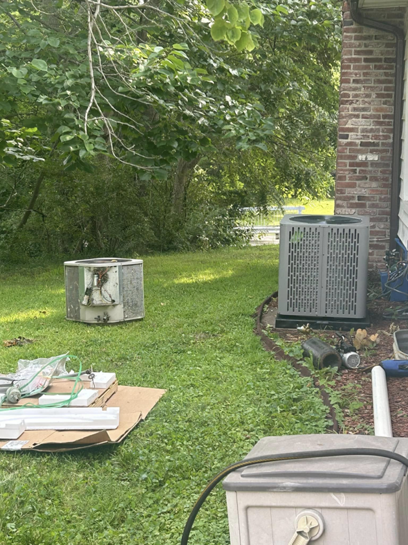 A severely damaged outdoor AC unit requiring inspection or replacement by Guy's Heating And Cooling in Kansas City, MO.
