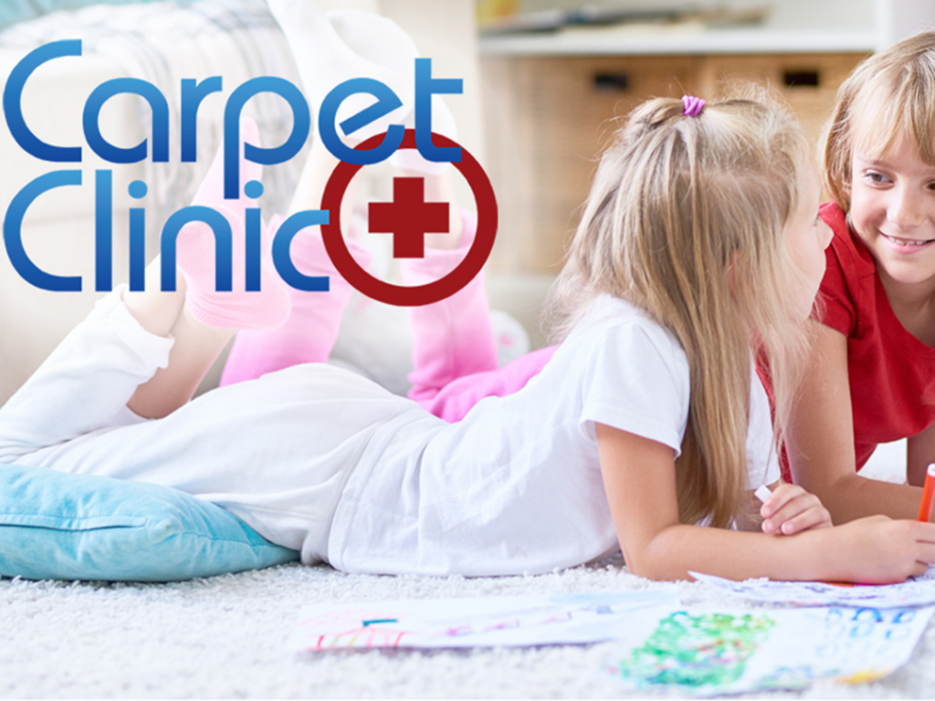 Close-up of damaged carpet needing repair around a wooden door frame, a service provided by St.Louis Carpet Clinic in St. Charles, MO.