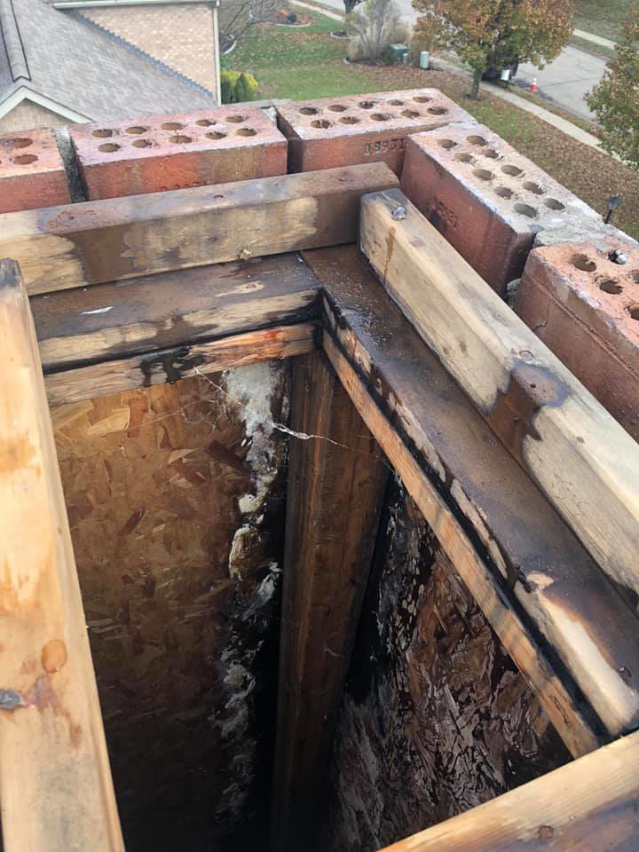 An interior view of a damaged chimney flue with water stains and mold, needing cleaning or repair by Al's Chimney Sweep in Pittsburgh, PA.