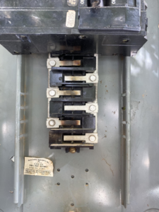 Damaged circuit breakers and bus bars inside an electrical panel, showing a need for repair by Sahuaro Electric LLC in Tucson, AZ.