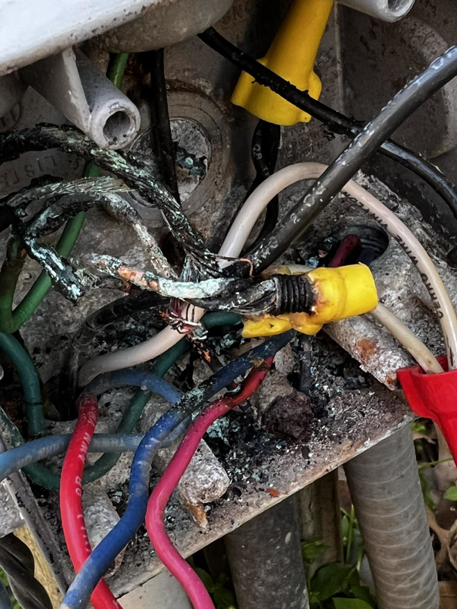 Severely damaged and corroded electrical wiring in a junction box, showing a repair need by APEX Electrical Design in Fort Worth, TX