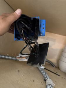 A damaged electrical box with burnt wiring found inside a cabinet by Dependable Sparky Electric in Peoria, AZ