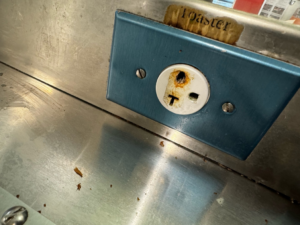 A close-up of a damaged electrical outlet needing repair from J. K. Quality Electric in Saint Bernard, LA.