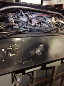 Close-up view of damaged electrical wiring and components, indicating a repair or inspection job by Sabteck Electric in Timmins, ON