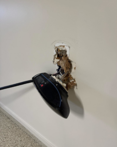 A damaged electric vehicle charger pulled from a wall, showing exposed wiring, repaired by Zimmerman Electric Indy in Indianapolis, IN