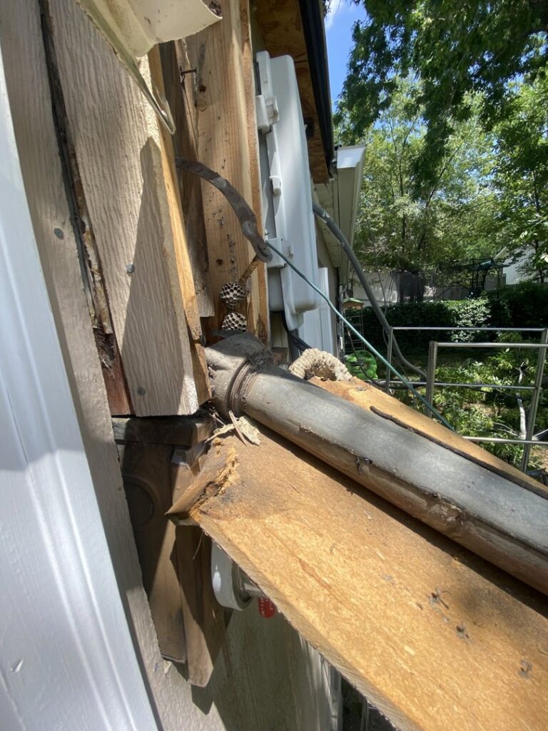Damaged exterior electrical conduit and wiring on a building, indicating a need for repair by Copper Canyon Electric in Farmington, UT.