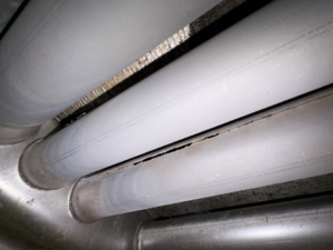 A damaged furnace heat exchanger requiring repair, inspected by Roy Rogers Heating and Air in Indianapolis, IN.