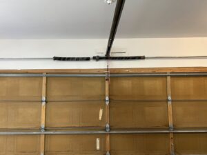 A damaged garage door torsion spring system requiring repair or replacement from SS Garage Door Repair in Denver, CO.