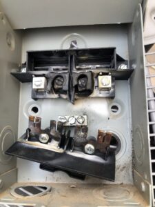 A damaged HVAC electrical disconnect box requiring repair by All Metro Air Conditioning in Apache Junction, AZ.