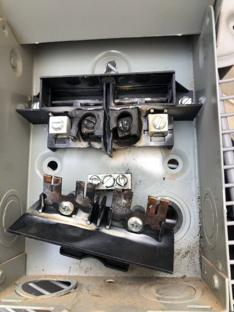 A damaged HVAC electrical disconnect box requiring repair by All Metro Air Conditioning in Apache Junction, AZ.