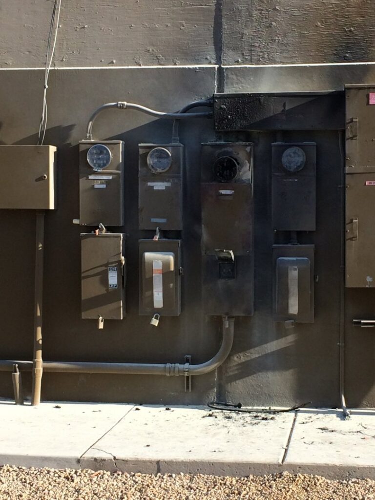 Damaged outdoor electrical meters and panels requiring service from Myres Electrical Service in Mesa, AZ