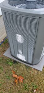A damaged outdoor HVAC condenser unit, showing bent fins, serviced by Weather Crafters in Williamsburg, VA.
