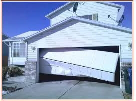 A severely damaged residential garage door in need of repair, showcasing a typical job for Az Garage Door in Phoenix, AZ.