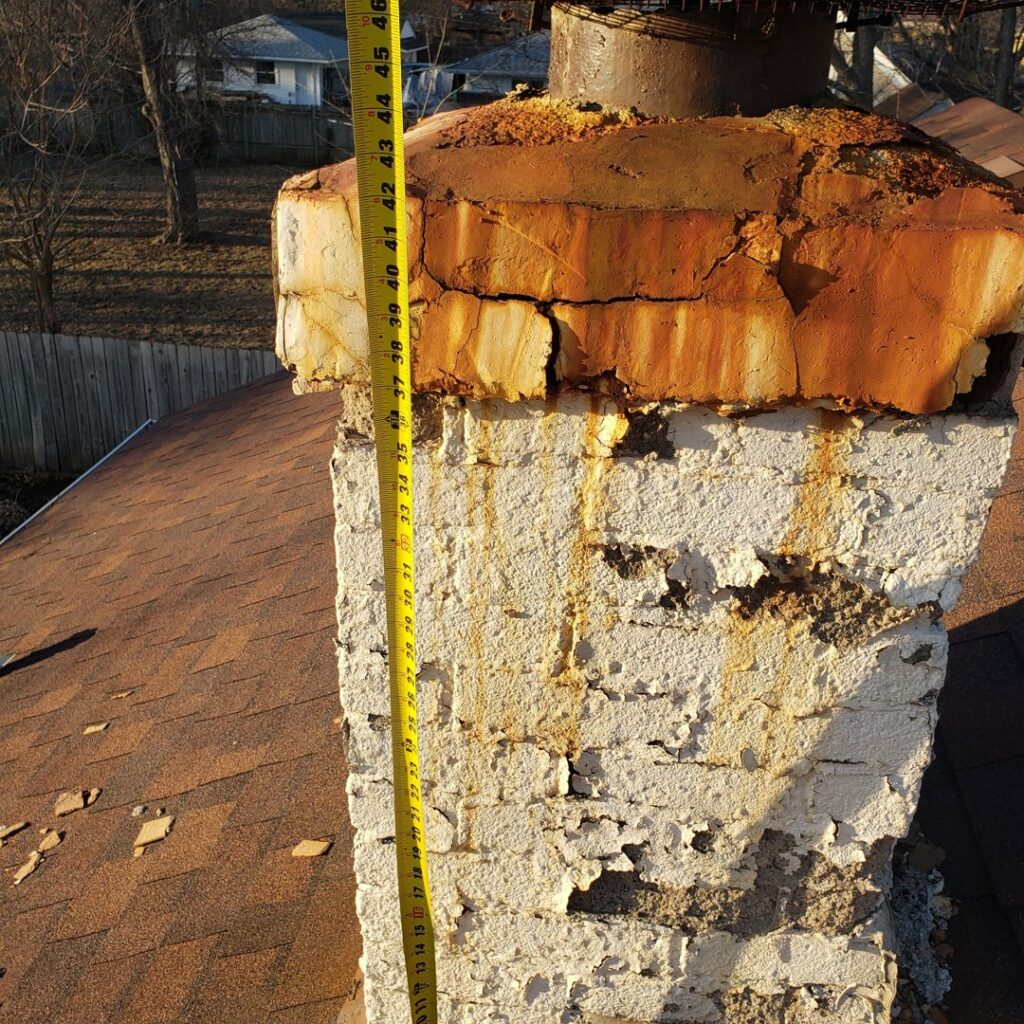 A severely damaged and rusted chimney top being inspected by JJ Chimney Services in Minneapolis, MN.
