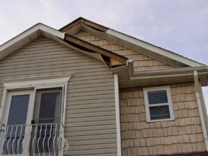 Damaged siding and roofline on a house, showing a wildlife entry point for ZooPro Wildlife Removal in Virginia Beach, VA.