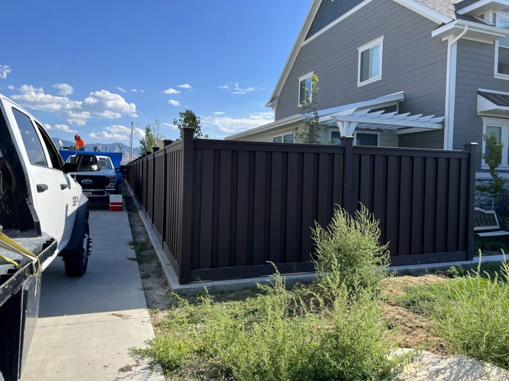 A newly installed dark brown privacy fence alongside a residential property by All Over Fence Idaho in Jerome, ID