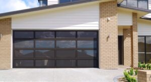 A dark glass modern garage door installed by Revolution Garage Door, LLC in Corvallis, OR.