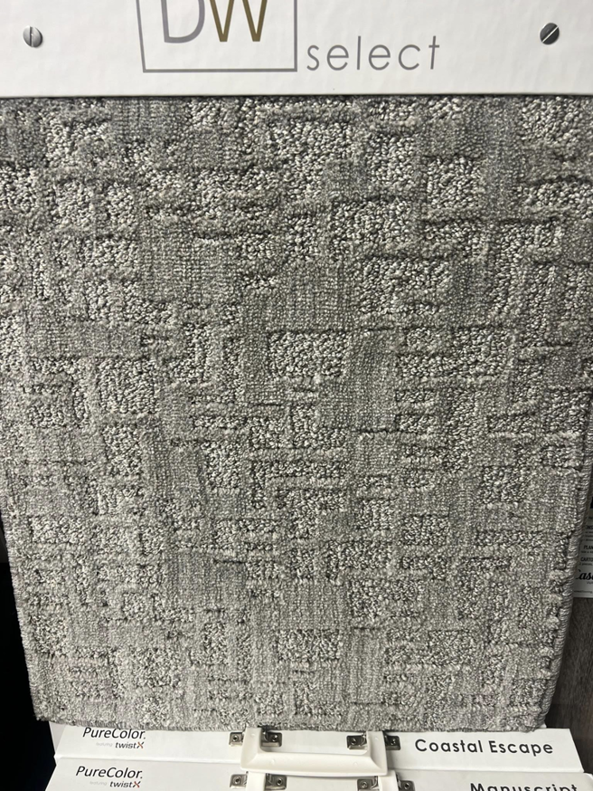 A close-up of a dark gray square pattern carpet sample at West Michigan Flooring & Interiors in Byron Center, MI.