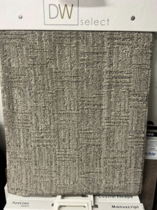 A close-up of a dark gray textured carpet sample at West Michigan Flooring & Interiors in Byron Center, MI.