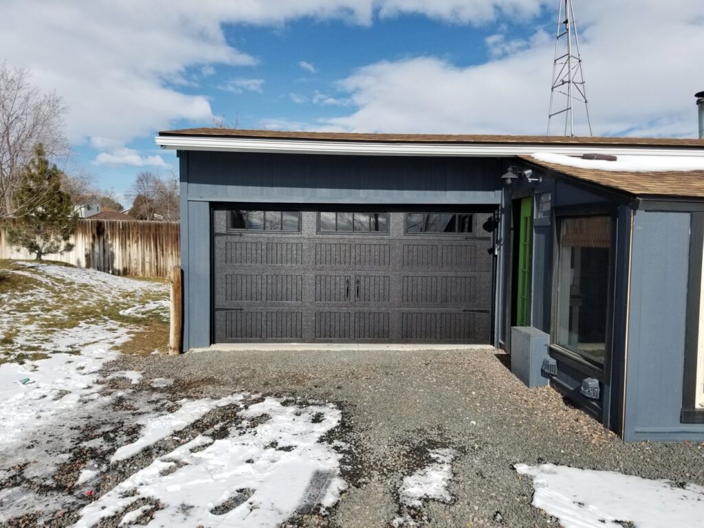 A dark gray textured garage door on a residential property installed by Colorado Garage Door Pro's in Denver, CO