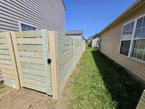 A dark gray and white vinyl privacy fence installed by Hoplite Services in Indianapolis, IN.