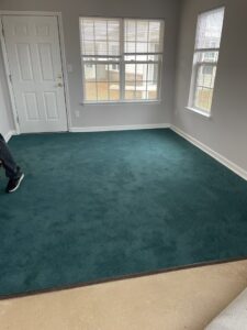 A room with newly installed dark green carpet by Johnson City Flooring & Finish, LLC in Johnson City, TN