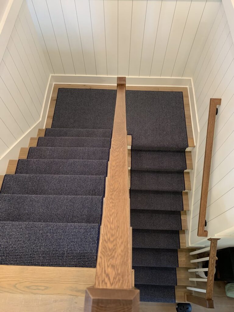 A dark grey-blue carpet stair runner installed by The Carpet Workroom in Needham Heights, MA.