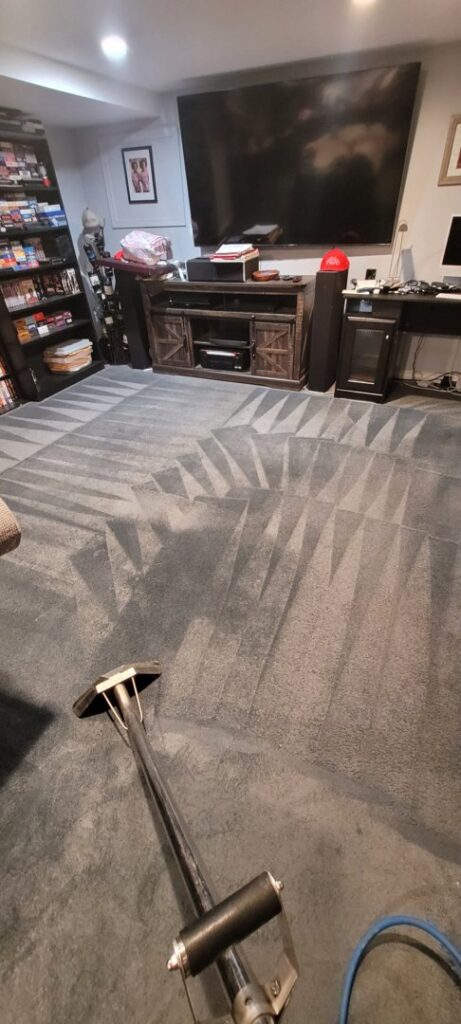 Carpet cleaning wand in action on a dark grey carpet by PDX STAR in Happy Valley, OR