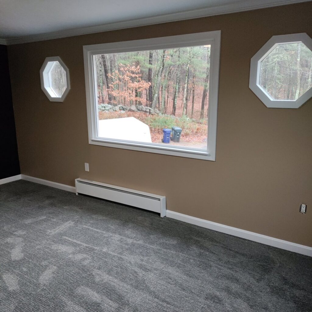 A residential room showcasing a new dark grey carpet installation by National Carpet and Flooring in Tyngsboro, MA.